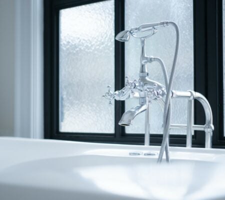 Bathroom faucet and sink in modern bathroom with sunlight