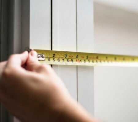 Man measuring with yellow meassure tape